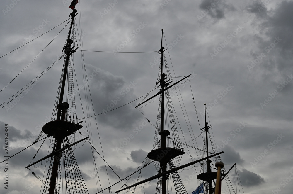 Sailing Ship's Rigging Silhouette Against Cloudy Sky at Dusk
