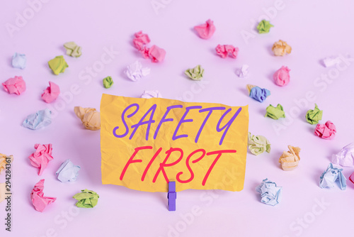 Word writing text Safety First. Business photo showcasing said to mean that it is best to avoid any unnecessary risks Colored crumpled papers empty reminder white floor background clothespin