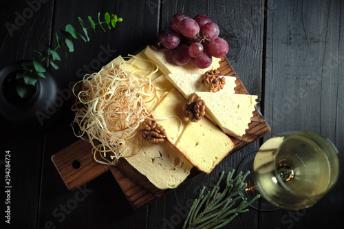 Glass of cold white wine with cheese snack on a wooden. catering menu