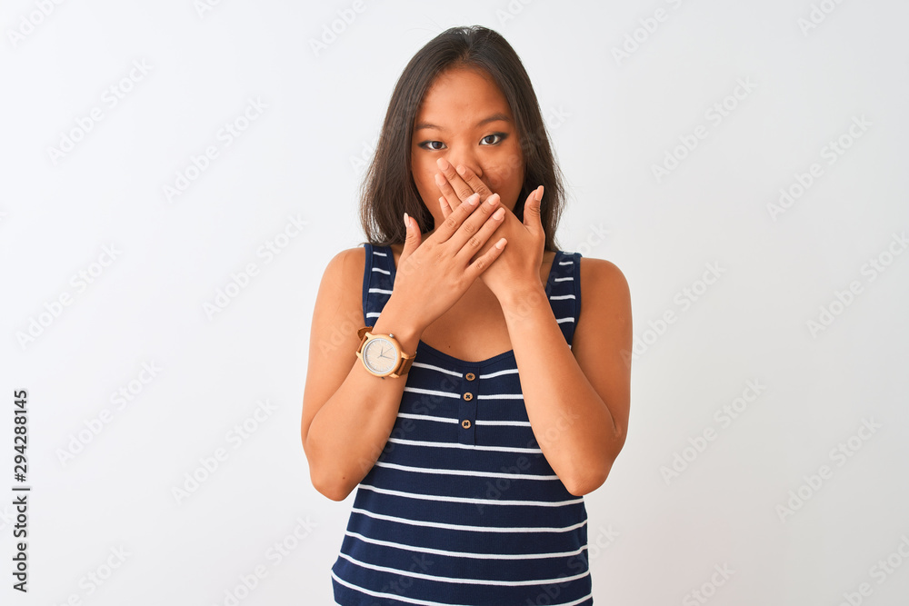 Young chinese woman wearing striped t-shirt standing over isolated white background shocked covering mouth with hands for mistake. Secret concept. Young chinese woman wearing striped t-shirt standing over isolated white background shocked covering mouth with hands for mistake. Secret concept.