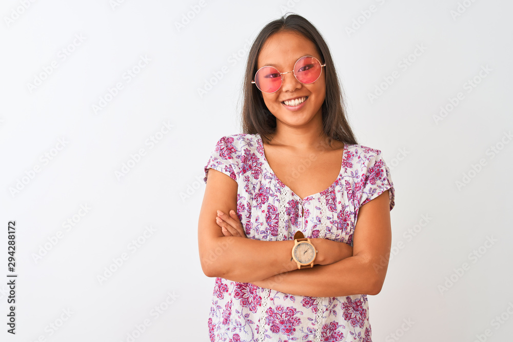 Young chinese woman wearing floral t-shirt and pink glasses over isolated white background happy face smiling with crossed arms looking at the camera. Positive person. Young chinese woman wearing floral t-shirt and pink glasses over isolated white background happy face smiling with crossed arms looking at the camera. Positive person.