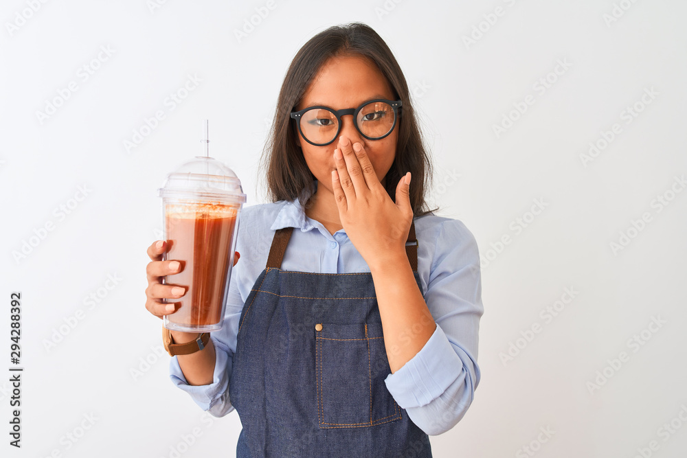 Chinese woman wearing glasses apron drinking smoothie over isolated white background cover mouth with hand shocked with shame for mistake, expression of fear, scared in silence, secret concept Chinese woman wearing glasses apron drinking smoothie over isolated white background cover mouth with hand shocked with shame for mistake, expression of fear, scared in silence, secret concept