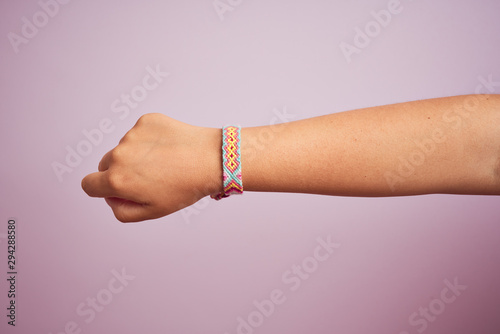 Model arm with beautiful handmade colorful bracelet on wrist photo