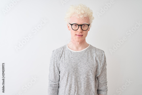 Young albino blond man wearing striped t-shirt and glasses over isolated white background Relaxed with serious expression on face. Simple and natural looking at the camera.
