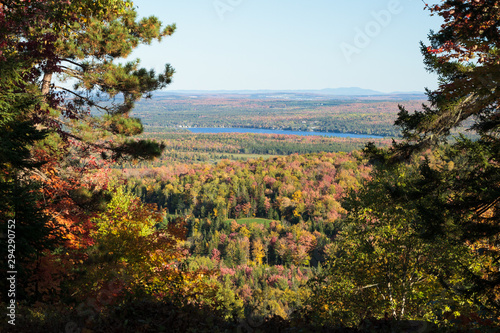 autumn landscape with trees and blue sky. View of Bolduc Lake and golf course, Adstock, Quebec, Canada