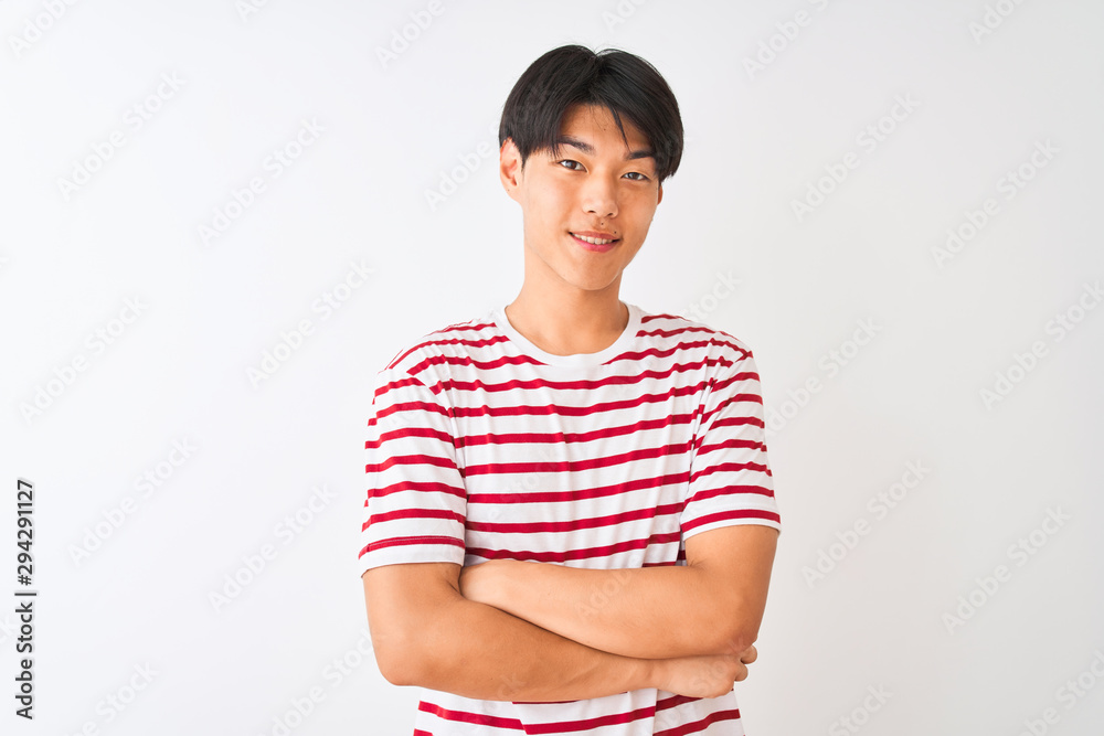 Young chinese man wearing casual striped t-shirt standing over isolated white background happy face smiling with crossed arms looking at the camera. Positive person. Young chinese man wearing casual striped t-shirt standing over isolated white background happy face smiling with crossed arms looking at the camera. Positive person.