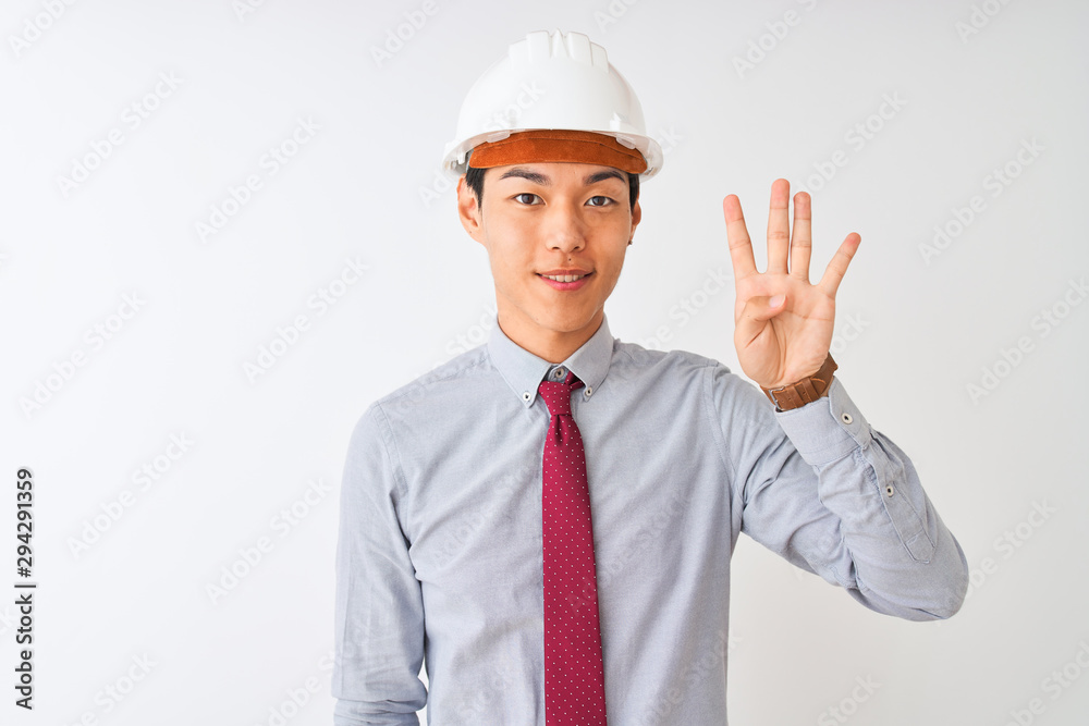 Chinese architect man wearing tie and helmet standing over isolated white background showing and pointing up with fingers number four while smiling confident and happy.