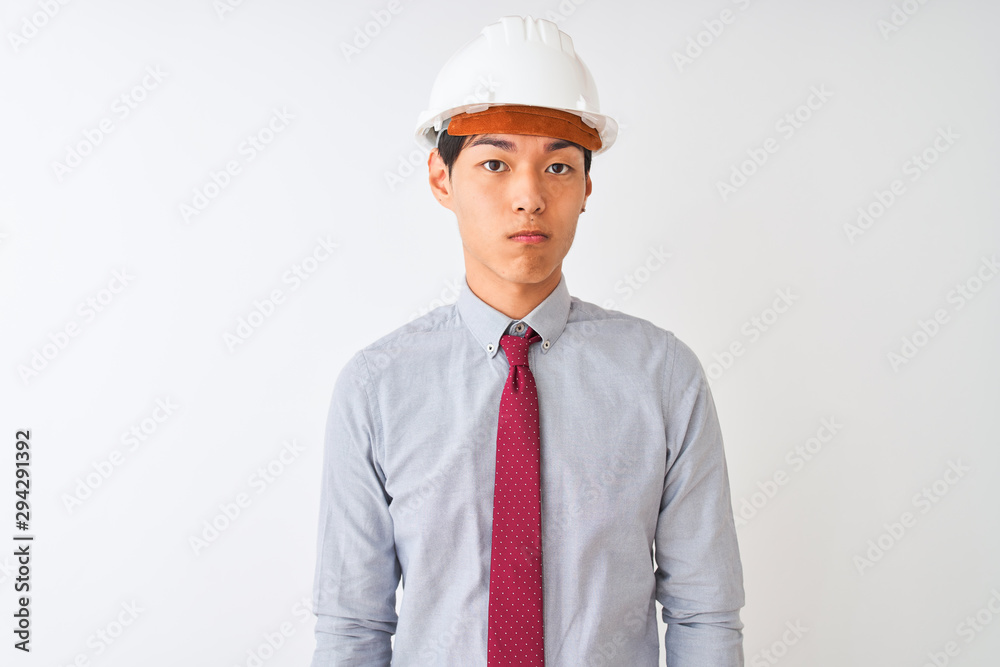 Chinese architect man wearing tie and helmet standing over isolated white background depressed and worry for distress, crying angry and afraid. Sad expression. Chinese architect man wearing tie and helmet standing over isolated white background depressed and worry for distress, crying angry and afraid. Sad expression.