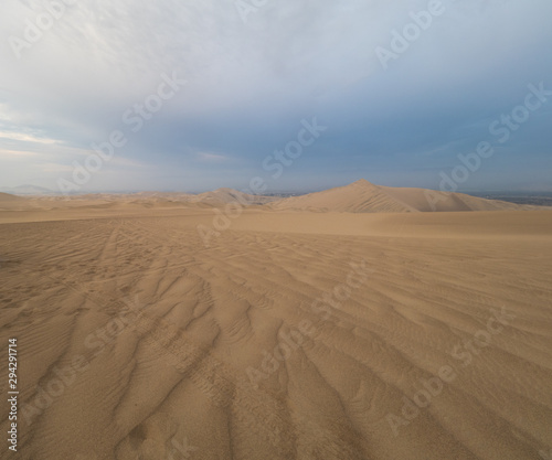 tire tracks over the sand at Ica desert  dunes in the horizon