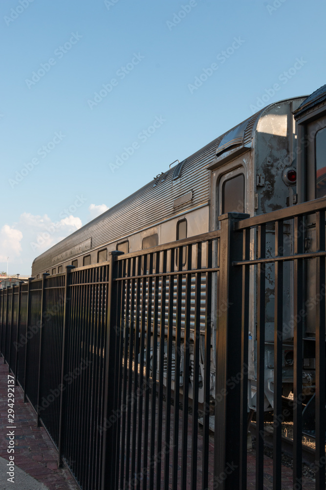 Train Car Behind Fence on a Sunny Afternoon Train Car Behind Fence on a Sunny Afternoon