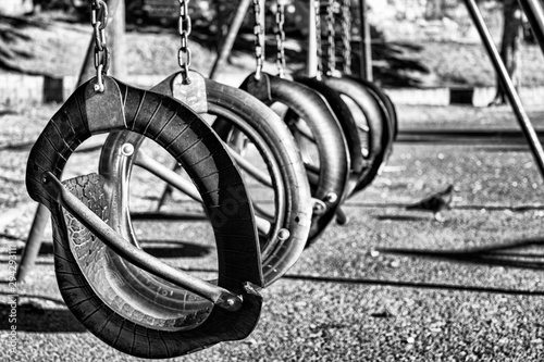 Black and white close up of a playground swing constructed using old motorvehicle tyres photo