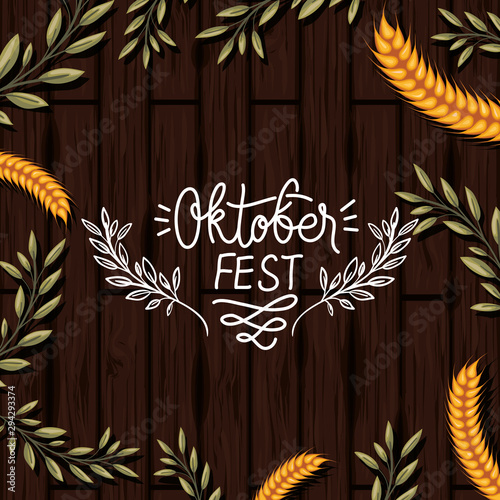 oktoberfest leafs and wheat spikes in wooden background