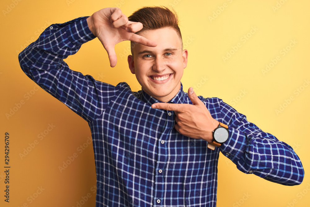 Young handsome man wearing casual shirt standing over isolated yellow background smiling making frame with hands and fingers with happy face. Creativity and photography concept. Young handsome man wearing casual shirt standing over isolated yellow background smiling making frame with hands and fingers with happy face. Creativity and photography concept.