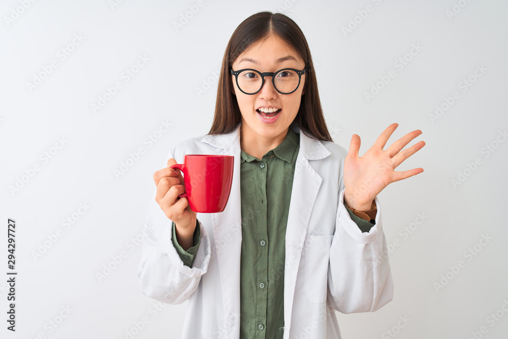 Young chinese dooctor woman wearing glasses drinking coffee over isolated white background very happy and excited, winner expression celebrating victory screaming with big smile and raised hands Young chinese dooctor woman wearing glasses drinking coffee over isolated white background very happy and excited, winner expression celebrating victory screaming with big smile and raised hands