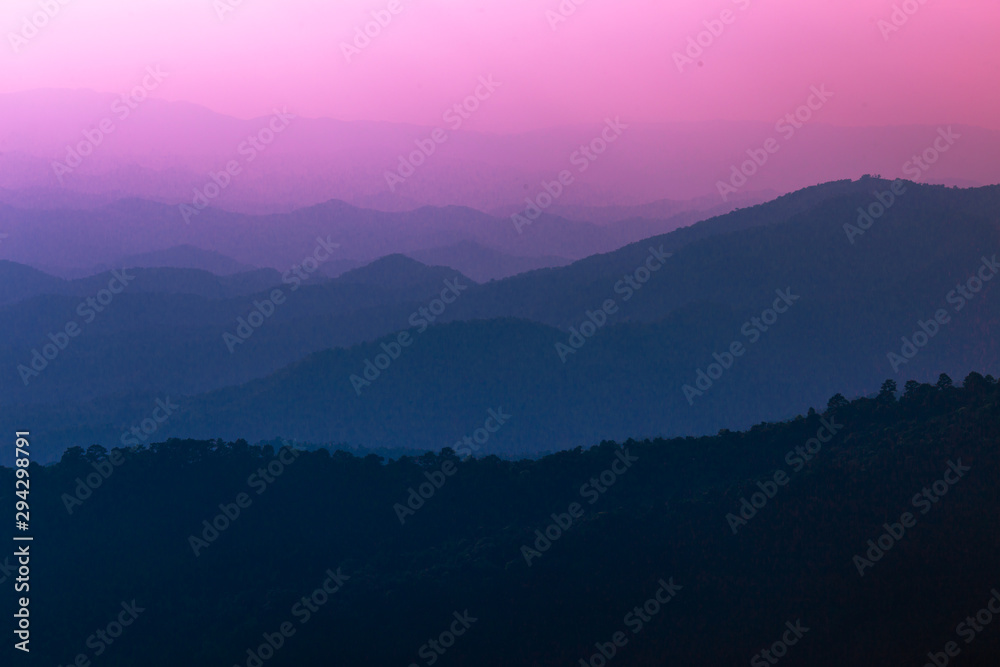 Wide natural background blurred by the bright sunlight above the mountains during the reversal of the horizon, beautiful twilight light, cold wind blowing through, fresh air