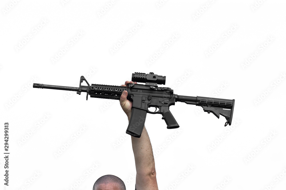 Man Holding AR15 or AR16 Automatic Assault Rifle In Air Above His