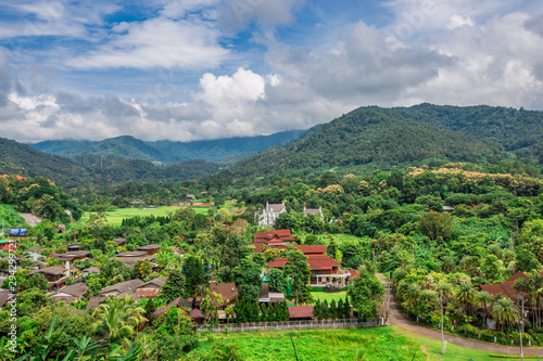 High angle panoramic wallpaper that overlooks nature all around (mountains, trees, green fields, roadside shelters), spontaneous beauty, cool, fresh air, breeze blowing through. Blur during the day © bangprik