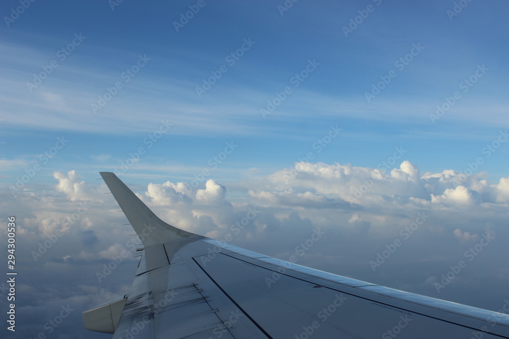 Plane wing in clouds