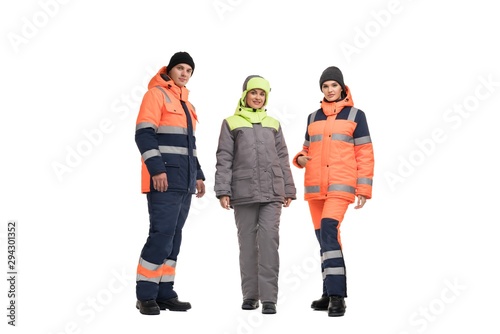 Young man and women in work clothes and caps shot