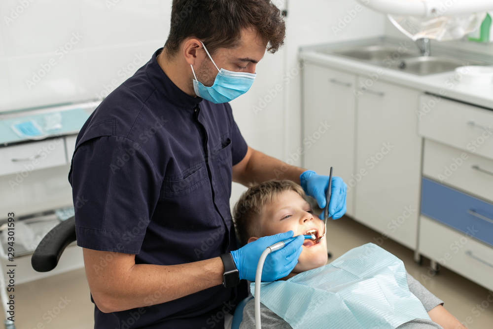custom made wallpaper toronto digitalDentist in black shirt drilling tooth of his young patient