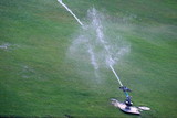 Nozzles are watering the field. care watering soccer fields.