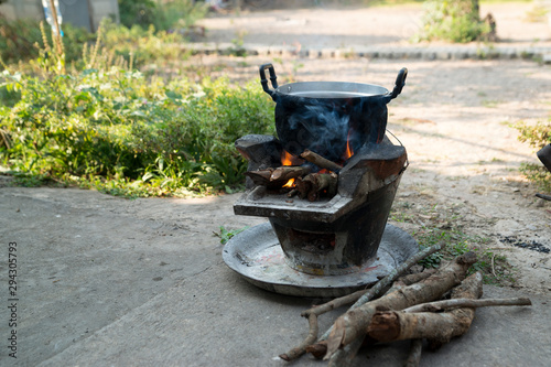Fotografija Old cooking pot stove using firewood As fuel.