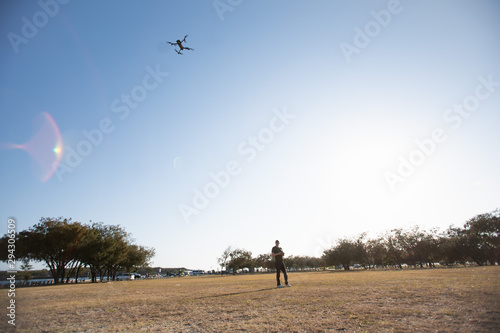 a man control drone practice at park open field area hobby flying air craft 