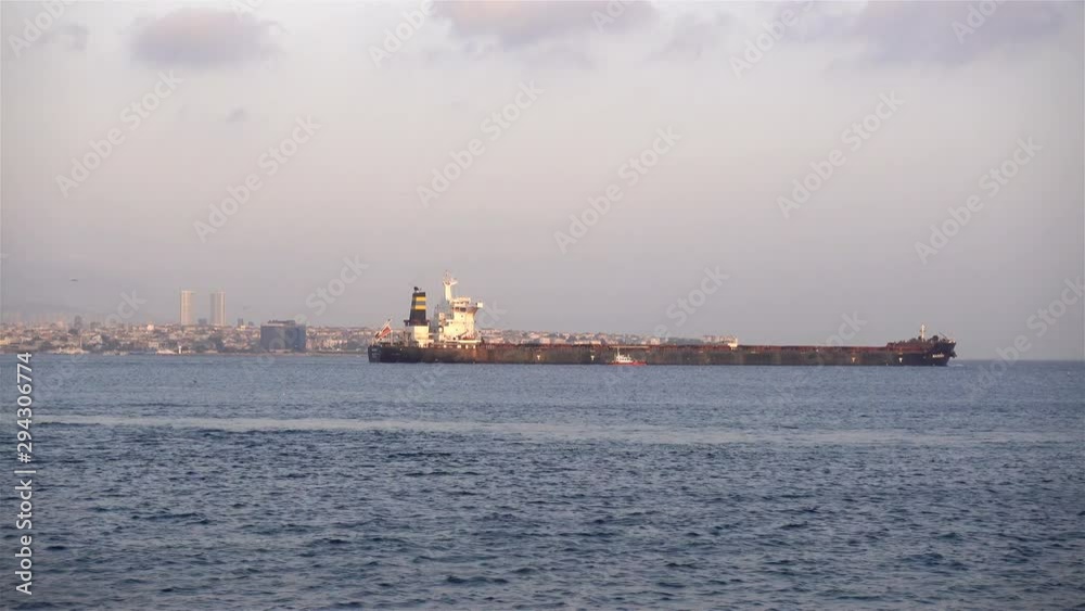 4K view of a dry cargo ship moving on water with views of Istanbul on the horizon. 4K view of a dry cargo ship moving on water with views of Istanbul on the horizon.