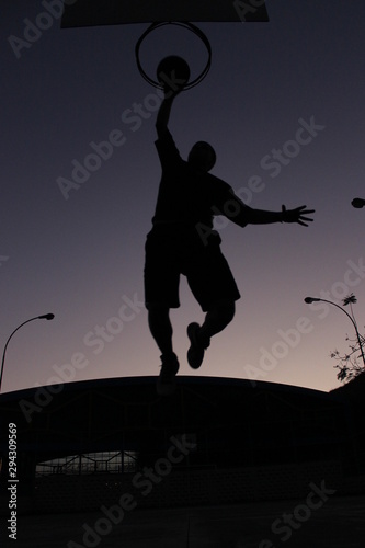 silhouette of man jumping on background of tree
