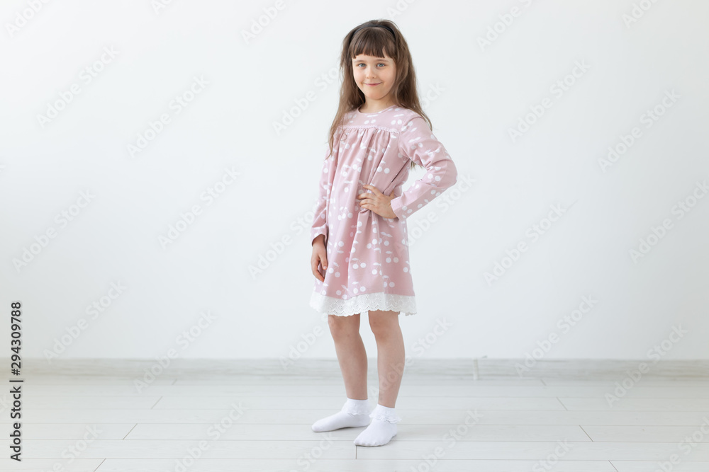 model, clothing designer, people concept - little girl model in pink dress over the white background model, clothing designer, people concept - little girl model in pink dress over the white background