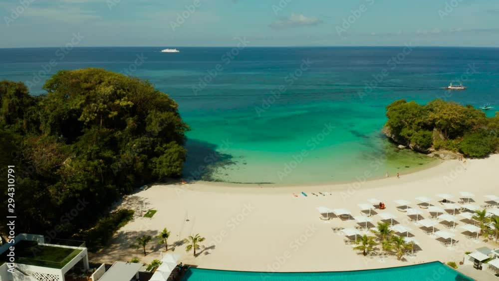 Blue sea and white sandy beach in sunny weather. Beautiful sea coast on the island of Barokai, Philippines, top view. Blue sea and white sandy beach in sunny weather. Beautiful sea coast on the island of Barokai, Philippines, top view.