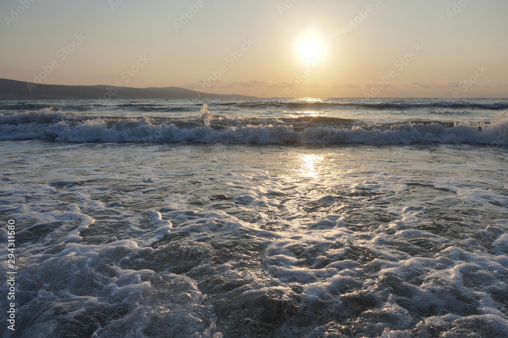Fototapeta premium Nature in twilight period which including of sunrise over the sea and the nice beach. Summer beach with blue water and purple sky at the sunset.