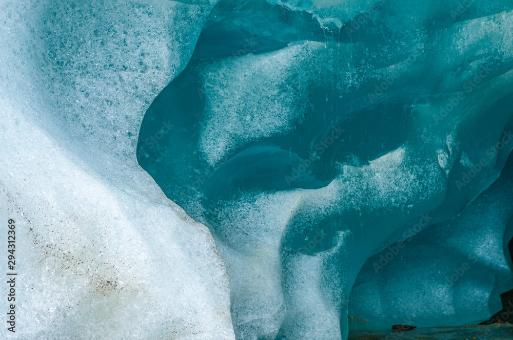 Fototapeta premium Melting clean blue ice in glacier ice cave.