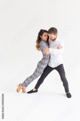 Passionate couple dancing social danse kizomba or bachata or tango or salsa on white background