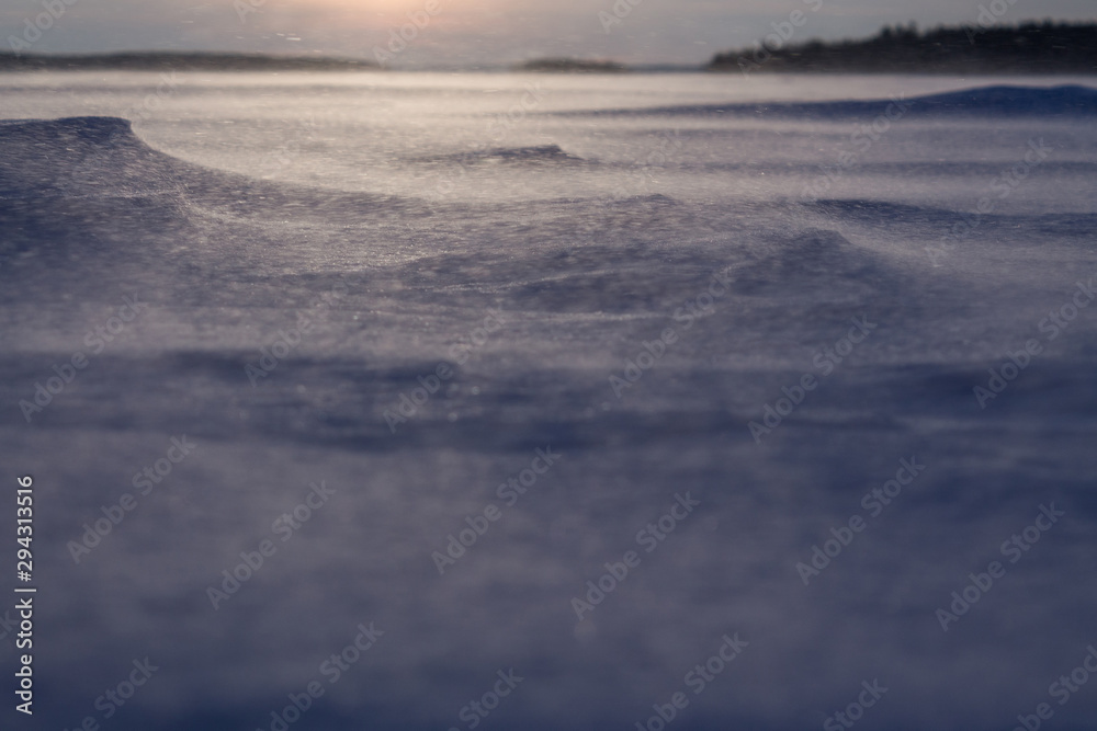 Dawn on the frozen lake. Strong wind and Blizzard. Low freezing temperature.