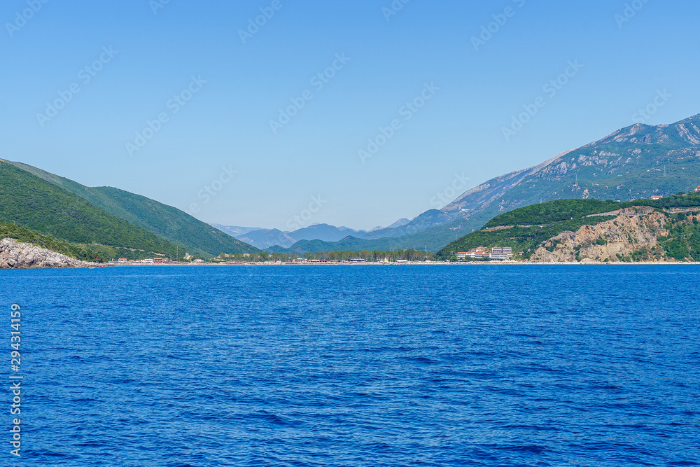 Budva Riviera in Montenegro, view from the sea on a summer day Budva Riviera in Montenegro, view from the sea on a summer day