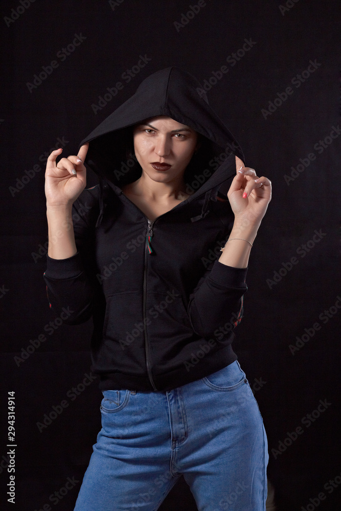 Model, a woman on a dark background in the Studio. Model, a woman on a dark background in the Studio.