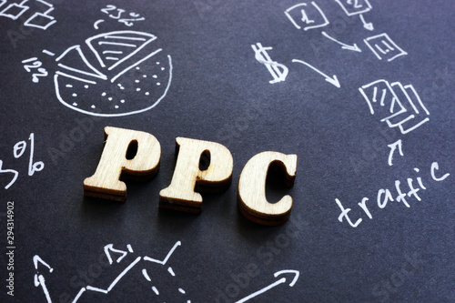 PPC pay per click sign on black paper. photo