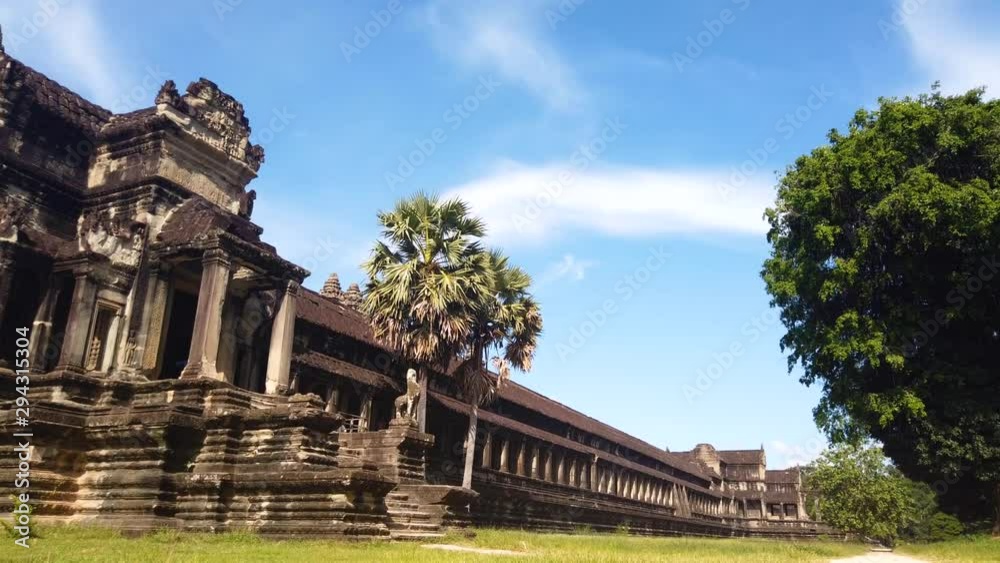 Motion timelapse showing largest religious monument in the world, Angkor Wat, a temple complex in Cambodia surrounded in clean green environment. Motion timelapse showing largest religious monument in the world, Angkor Wat, a temple complex in Cambodia surrounded in clean green environment.