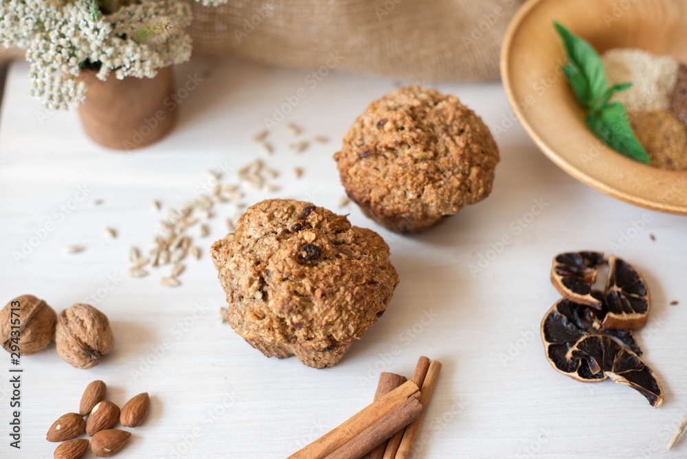Whole wheat flour muffins. Sugar-free dessert, Healthy diet. Beautiful composition of flowers, ingredients and dessert Whole wheat flour muffins. Sugar-free dessert, Healthy diet. Beautiful composition of flowers, ingredients and dessert
