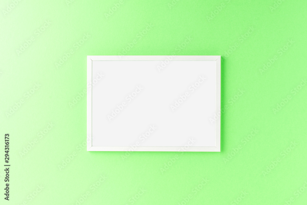 Empty picture frame on green wall. Mockup with copyspace Empty picture frame on green wall. Mockup with copyspace