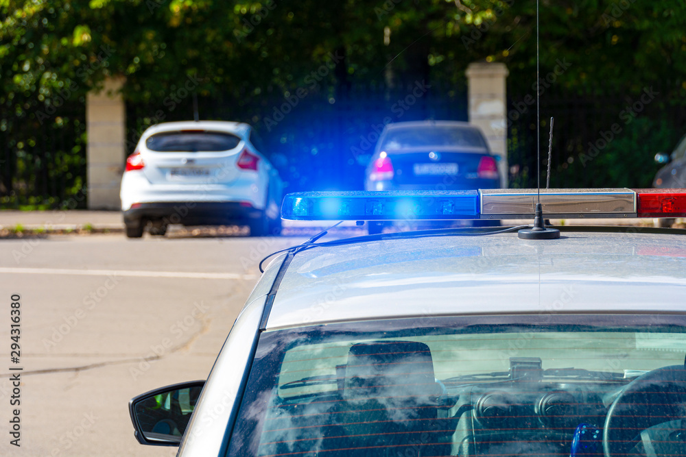 police car lights in the afternoon in the city with selective focus and blur bokeh