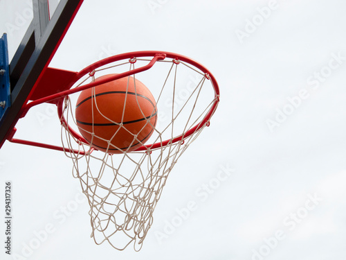 Basketball hit the net, the goal is achieved.  Basketball street game © BetterPhoto