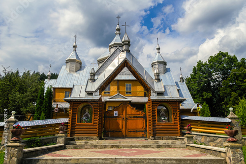 Verkhovyna, Ukraine. Beautiful wooden orthodox church on a background of summer cloudy sky.