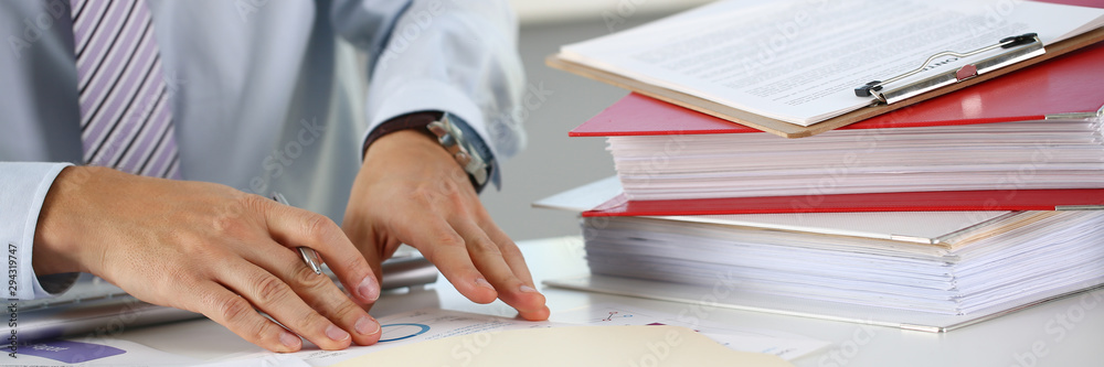 Male hands hold documents with financial statistics at office workspace closeup. White collar check money papers stock exchange market internal Revenue Service inspector earning list concept