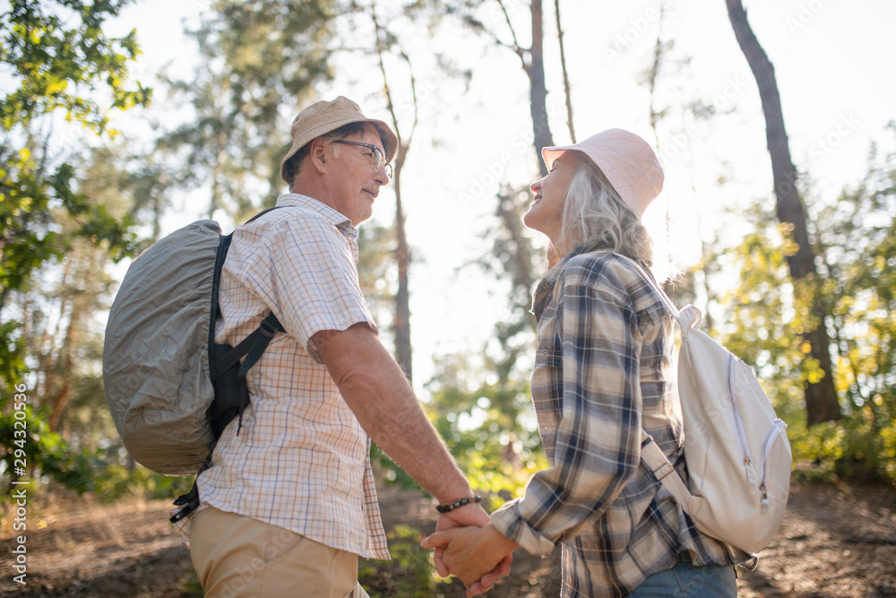 Couple wearing hats enjoying summer day in park Couple wearing hats enjoying summer day in park