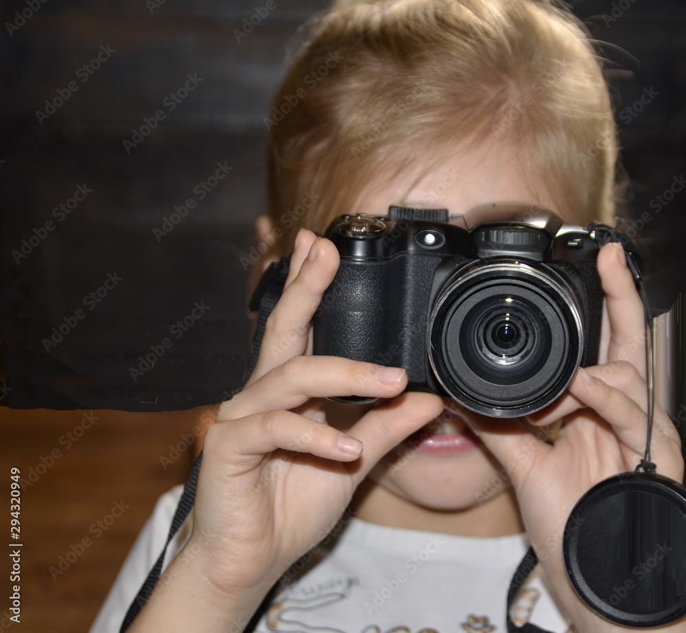 Favourite hobby. The camera is in the hands of a pretty girl. Favourite hobby. The camera is in the hands of a pretty girl.