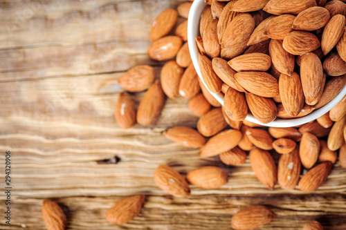 Wallpaper Mural Top view of almonds on wooden table. Almonds nuts concept. Torontodigital.ca