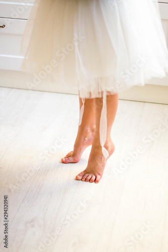ballerina feet on wooden floor