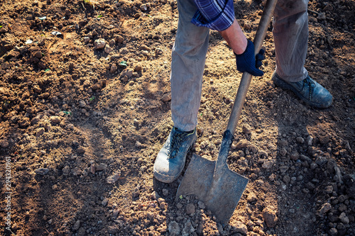 Man digging over earth with a spade
